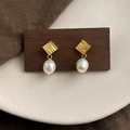 Macro detail of French vintage baroque pearl earrings with golden textured metal base - Style 28