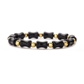 Detailed shot of dark blue goldstone bamboo-shaped beads and gold metal spacers on bracelet - Blue Sandstone