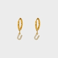 Close-up of gold-plated hoop earrings featuring a U-shaped pendant with pavé cubic zirconia - Letter U