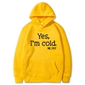 Detail of a bright yellow hoodie featuring bold Yes I'm cold black letter print design - S / Hooded / Yellow