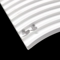 Macro view of silver bird-shaped titanium steel stud earrings on white wavy texture - Bird