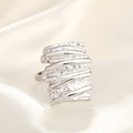 Close-up of a silver hammered texture wide ring on cream silk fabric background - Square Line Wrinkle / Silver