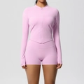 Detail of light pink yoga set featuring a front zipper top and high-waisted fitness shorts - Sakura Pink