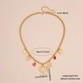 Collana a cuore in acciaio dorato con pietra rossa e ciondoli a stella su sfondo beige - Cuore Alato & Stella (4#素爱心)