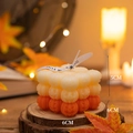 Halloween pumpkin cube candle with orange gradient layers and decorative white ribbon bow - Pumpkin Cube / Gradient Orange
