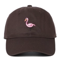 Detailed close-up of pink flamingo embroidery on dark brown cotton baseball cap fabric - Coffee
