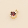 14k gold-plated round pendant featuring a vibrant 5mm red zircon stone with top loop - Red
