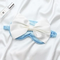 Pale blue silk-like sleep mask featuring a large white satin bow and elastic headband - Sky Blue