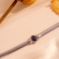 Macro shot of silver snake chain bracelet with a deep purple cat eye stone detail - Silver with Black Cat Eye Stone