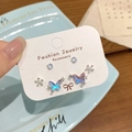 Three-pair stud set featuring iridescent butterflies and floral designs on display card - JC1 Butterfly Crystal Cluster