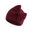 Close-up of deep red knitted baby hat featuring a large decorative bow on pure white background - Wine Red (Bow Turban Hat)