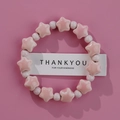 Pink ceramic star beaded bracelet on a pink background with a thank you card - Pink Star Round (1586-10)