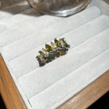 Detailed macro view of silver ring with green marquise-cut stones on gray velvet - Adjustable Open Style / Silver Green Oval