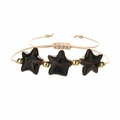Detailed view of handmade woven bracelet with starfish ceramic beads and gold accents - Copper Beads + Black Starfish