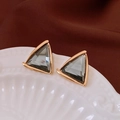 Macro view of triangular gold-framed earrings with smoky grey crystal insets - Smoky Grey Triangle Black Core Style