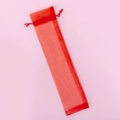 Red organza drawstring gift bag for pens and folding fans on a light pink background - 6*26CM / Red