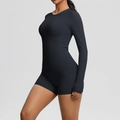 Detail view of black high-stretch long sleeve yoga top and high waist sports shorts on model - S / Black