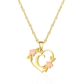 Detailed close-up of golden heart pendant with letter C and pink enamel flowers - Letter C