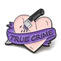True Crime enamel pin with pink heart, purple ribbon, and knife design for clothes - True Crime Heart