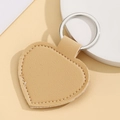 Detail of a beige heart-shaped PU leather keychain with high-quality metal ring - Heart Shape / Khaki