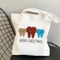 White canvas tote bag with festive tooth patterns and Merry Christmas text on mesh chair - C2 Christmas Teeth Merry Christmas