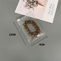Detail view of 13x9cm clear plastic jewelry storage bag with sliding zipper lock - 30 Silk 9*13cm (100 Pcs)