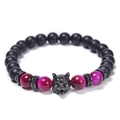 Detailed shot of wolf head bracelet with tiger eye stones and matte black beads - Pink Tiger Eye Style