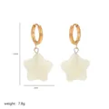 Detail shot of gold star drop earrings with size markers and white resin finish - Star Earrings (A2-05)