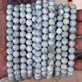 Macro shot of natural blue Larimar beads with distinctive sea-wave water patterns - Natural Larimar
