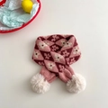 Detail of pink and crimson knitted scarf with flower patterns and beige pom-poms - Burgundy & Pink Argyle