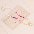 Bohemian clay bead necklace with pearls and gold heart pendant on a stone surface - Mixed Pink #3