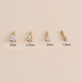 Detail of four gold vacuum plated stainless steel nose studs with zircons in various sizes - Straight Bar / 2.5mm / Gold