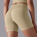 Close-up of high-waisted seamless knit sports shorts with push-up effect in khaki - S / Shorts / Light Camel