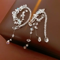 Macro shot of sparkling faceted crystal drop tassel earrings on a premium leather box - Long Tassel Water Drop / Silver Earring Post-White