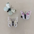 Three-piece set of butterfly hair clips featuring blue, pink, and yellow wing patterns - Grey White Hair Clip