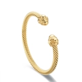 Adjustable golden twisted cable cuff bracelet with embossed ball ends on white background - Gold