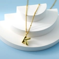 Golden bubble letter K pendant necklace with delicate bead chain on a modern stand - Letter K(K)