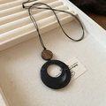 Detail view of retro wood beads and round resin starfish pendant necklace on a jewelry tray - 58# Necklace - Black - Brown