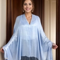 Light blue shimmering shawl with fringe tassels worn by a model in an indoor setting - Standard / 180x70cm / Light Blue