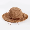 Detailed close-up of dark brown handmade woven straw sun hat with wavy brim and bow - Adult M (56-58cm) / Khaki