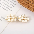 Macro shot of an elegant bow hair clip featuring cat's eye stones and sparkling crystals - Style 5 Large Bow Tie