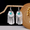 Macro detail of ethnic silver earrings with turquoise stones and bells on a wooden branch - Silver Artificial Turquoise Tassel Style (E2871-14)