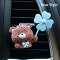 Detail of Teddy Bear car air vent clip with blue bow and four-leaf clover fan decoration - Brown Bear