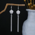 Detail of silver long tassel earrings with flower pattern on wooden branch - Vintage Flower Fine Tassel Style (E3291)