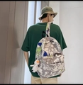 Detail view of graffiti print backpack with white duck pendant on a female model's back - No Pendant / Gray