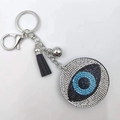 Blue evil eye keychain with sparkling rhinestones and a stylish black tassel pendant - White