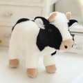 Cute standing cow plush toy with black and white fur, brown horns and soft filling - Cow