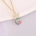Macro shot of 18K gold plated crown letter G pendant with colorful zircon stones - Letter G Style
