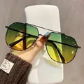 Aviator sunglasses with black metal frame and green-yellow gradient lenses hand-held - Black Frame Green Yellow Gradient Lens