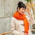 Vibrant orange cashmere-like tassel scarf styled with a beige toggle coat for women - Orange Red